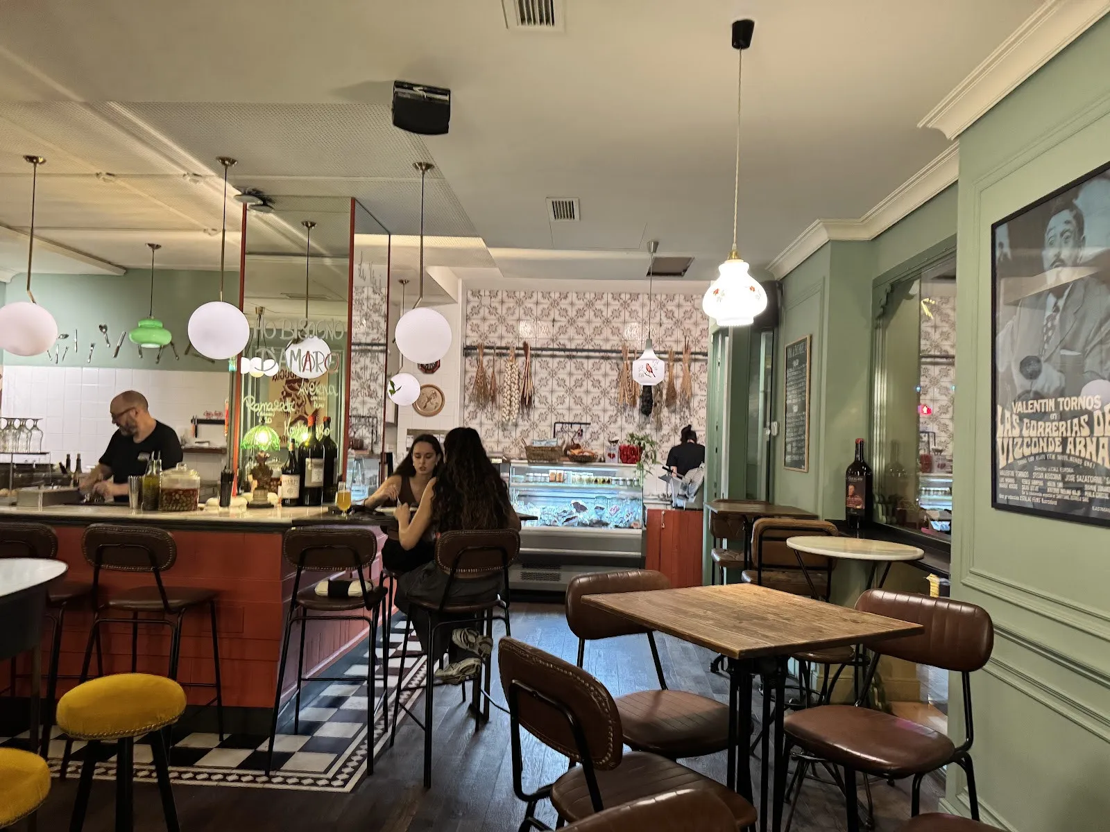 Inside Benditto: the bar, high tables and green walls