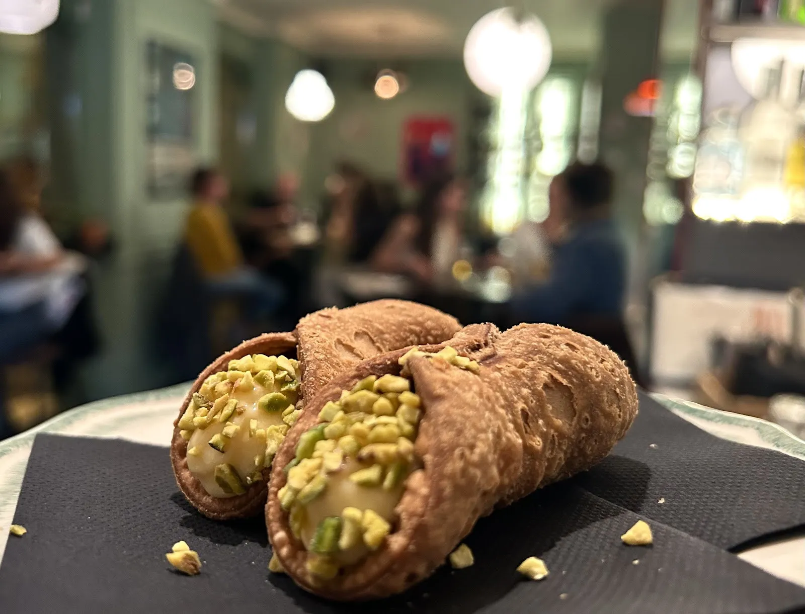 Two cannoli with pistachio